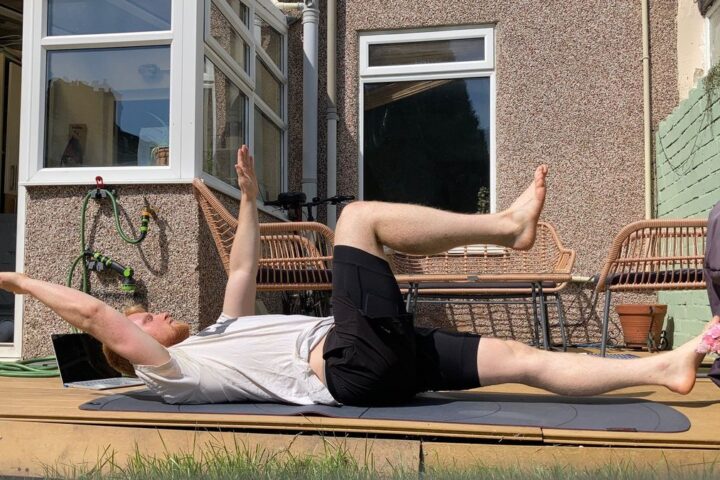 Author Harry Bullmore performing the dead bug exercise outside