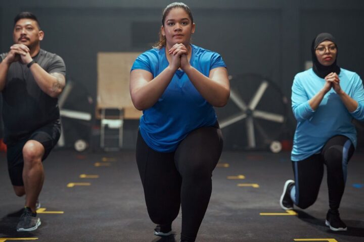 Three people performing lunges