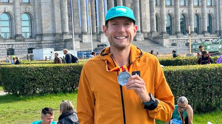 Nick Harris-Fry holding a Berlin Marathon finisher&rsquo;s medal