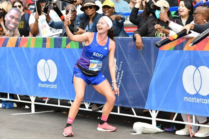 Runner Sofia Maria Jimenez stops and takes a picture with fans during the 2022 TCS New York City Marathon