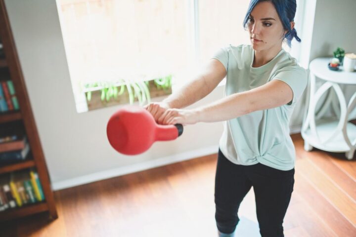 Woman performs kettlebell swing