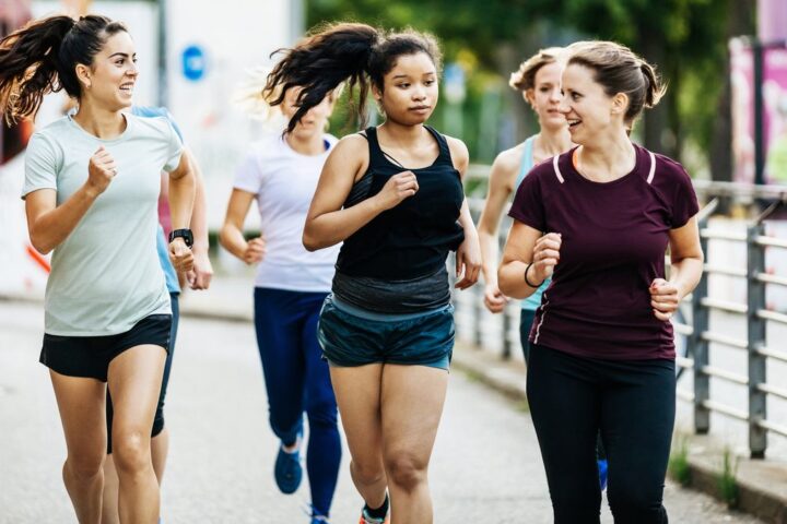 Group of runners talking as they run