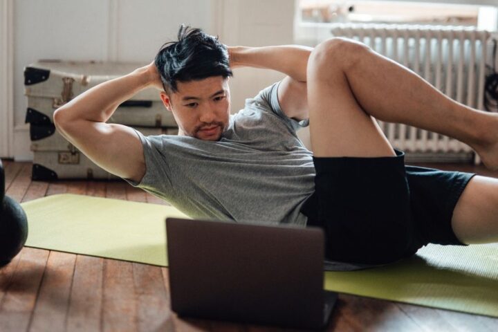Man performing bicycle crunch exercise at home