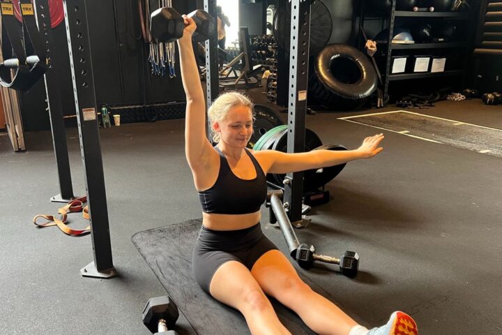 Woman performing Z press in gym